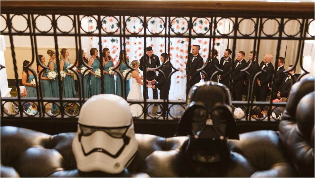 Premier snohomish & seattle wedding photographer | gsquared weddings photography two people are getting married in front of their wedding party with guests watching In the foreground star wars stormtrooper and darth vader helmets sit over the back of a couch at this fun snohomish seattle wedding | serving snohomish seattle                   & beyond