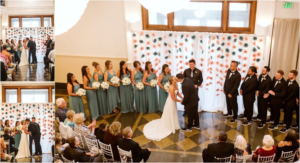 Premier snohomish & seattle wedding photographer | gsquared weddings photography a beautiful snohomish wedding ceremony with a bride and groom kissing at the altar surrounded by bridesmaids in teal dresses groomsmen in black suits and guests seated before a white flower backdrop Perfect for a seattle wedding engagement celebration | serving snohomish seattle                   & beyond