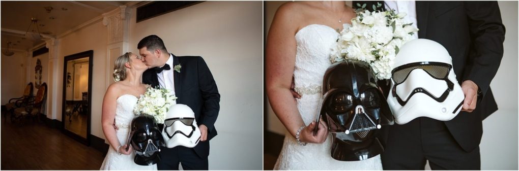 Premier snohomish & seattle wedding photographer | gsquared weddings photography a bride and groom kiss indoors at their snohomish seattle wedding holding a bouquet of white flowers and two star wars helmetsone darth vader and one stormtrooperin their hands | serving snohomish seattle                   & beyond