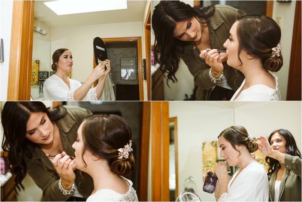 Premier snohomish & seattle wedding photographer | gsquared weddings photography a bride gets ready for her snohomish wedding a makeup artist applies lipstick the bride checks her reflection in a mirror and another woman helps adjust her hair She wears a white robe and has her hair styled in an elegant updo | serving snohomish seattle                   & beyond