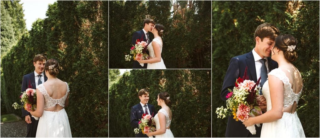 Premier snohomish & seattle wedding photographer | gsquared weddings photography a bride and groom stand together outdoors in snohomish holding a colorful bouquet and smiling at each other in front of tall green bushes enjoying their seattle wedding day | serving snohomish seattle                   & beyond