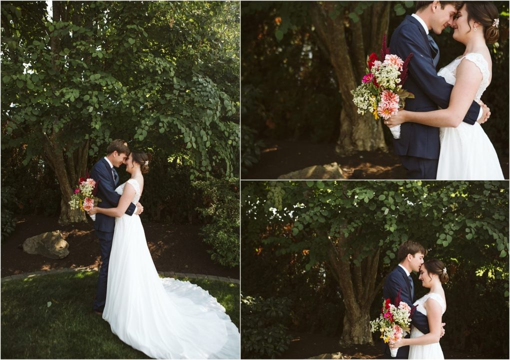 Premier snohomish & seattle wedding photographer | gsquared weddings photography a bride and groom stand outdoors in a lush snohomish garden embracing and smiling at each other The bride holds a bouquet of colorful flowers and wears a white dress while the groom wears a navy suit at their seattle wedding | serving snohomish seattle                   & beyond
