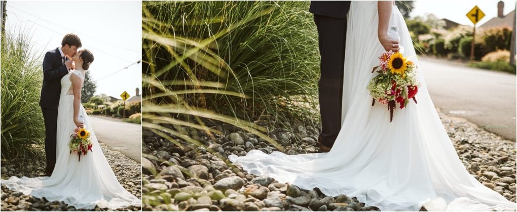 Premier snohomish & seattle wedding photographer | gsquared weddings photography a bride in a white dress holding a sunflower bouquet embraces her groom on a rocky path beside tall grass sunlight streaming behind them A street sign hints at their romantic snohomish seattle wedding engagement | serving snohomish seattle                   & beyond