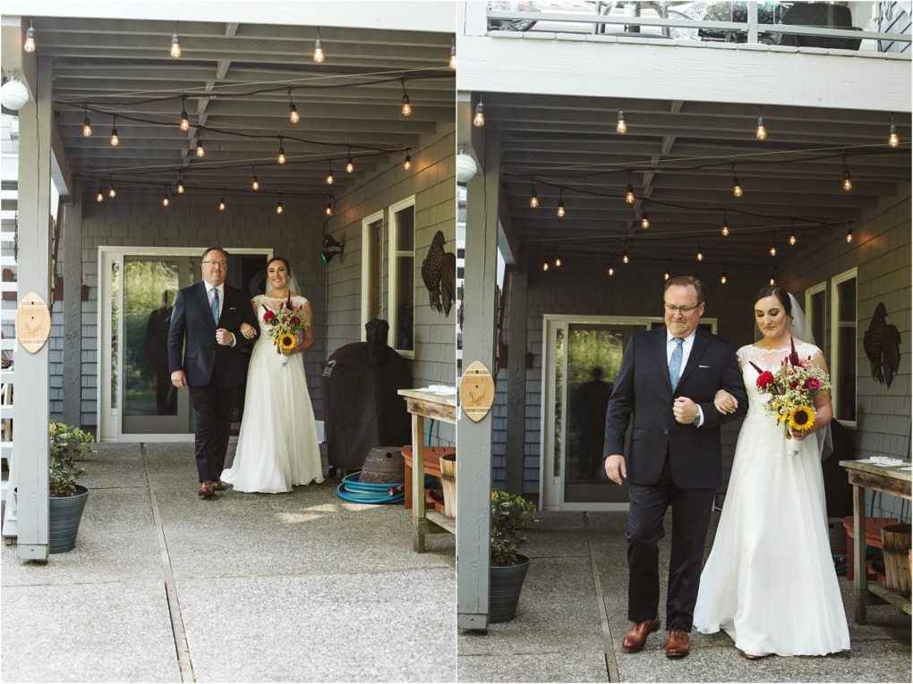 Premier snohomish & seattle wedding photographer | gsquared weddings photography a bride in a white dress holding a bouquet walks arm in arm with a man in a suit likely her father under string lights on a shaded patio at this snohomish wedding Both look ahead as they prepare to walk down the aisle | serving snohomish seattle                   & beyond