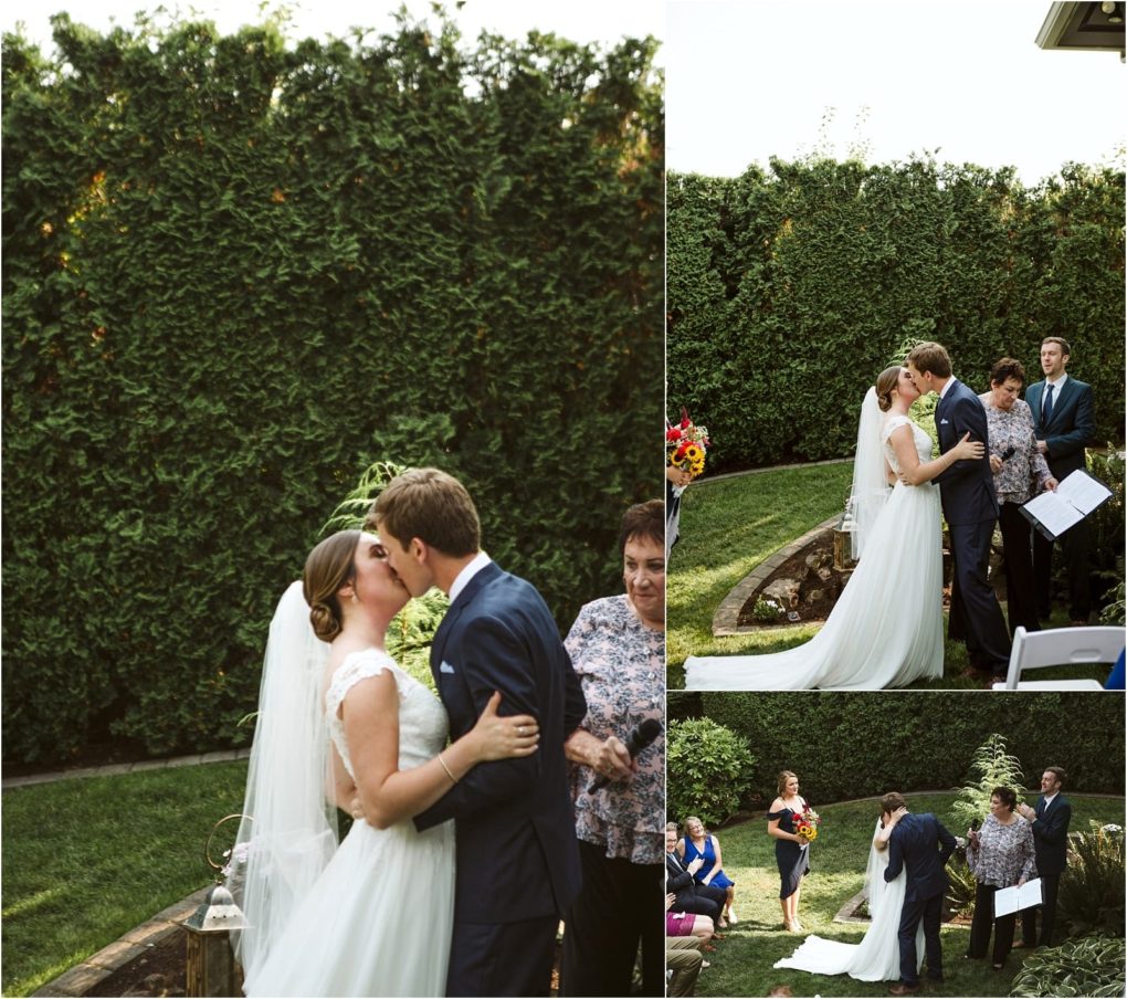 Premier snohomish & seattle wedding photographer | gsquared weddings photography a bride and groom kiss at their outdoor snohomish wedding ceremony in a garden surrounded by greenery with guests and an officiant nearby The couple stands close together in formal attire celebrating their marriage near seattle | serving snohomish seattle                   & beyond