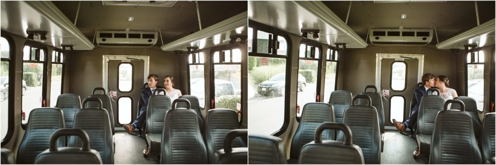 Premier snohomish & seattle wedding photographer | gsquared weddings photography a couple dressed in wedding attire sits together at the back of a mostly empty bus first looking ahead and then sharing a kiss Sunlight filters through the windowscapturing a quiet snohomish seattle wedding moment among empty seats | serving snohomish seattle                   & beyond