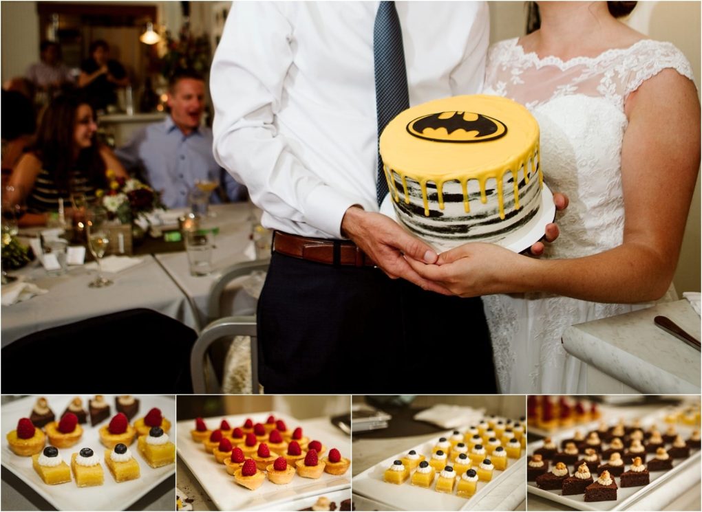 Premier snohomish & seattle wedding photographer | gsquared weddings photography a bride and groom at their snohomish wedding hold a batman themed cake Below trays of assorted mini dessertstarts and pastries with berries and creamare beautifully displayed at their seattle area reception | serving snohomish seattle                   & beyond