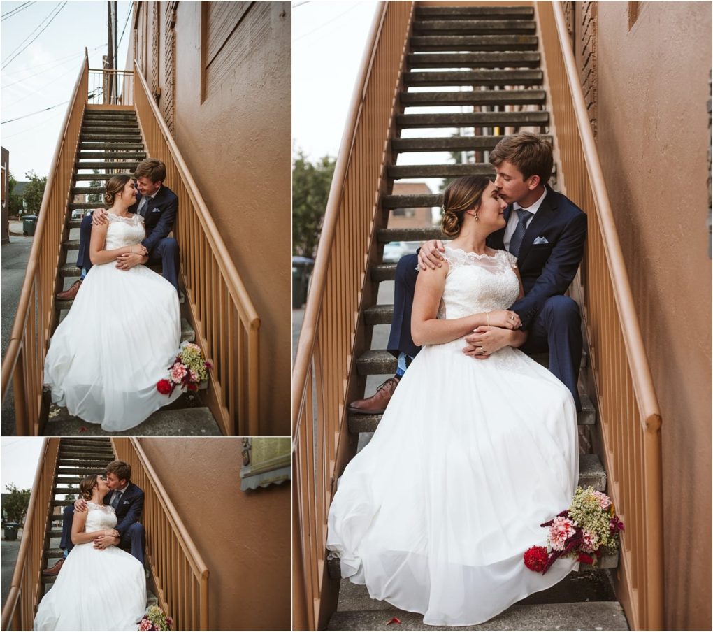 Premier snohomish & seattle wedding photographer | gsquared weddings photography a bride in a white dress and a groom in a navy suit sit close together on outdoor stairs embracing and smiling lovingly during their snohomish seattle wedding with a bouquet of flowers beside them | serving snohomish seattle                   & beyond