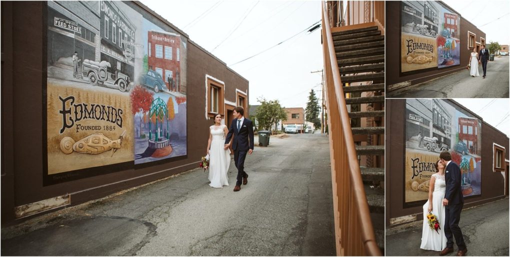 Premier snohomish & seattle wedding photographer | gsquared weddings photography a bride and groom walk together in an alley beside a large edmonds mural featuring vintage cars and local scenes The couple celebrating their snohomish wedding holds hands and smiles with the mural as a vibrant background | serving snohomish seattle                   & beyond