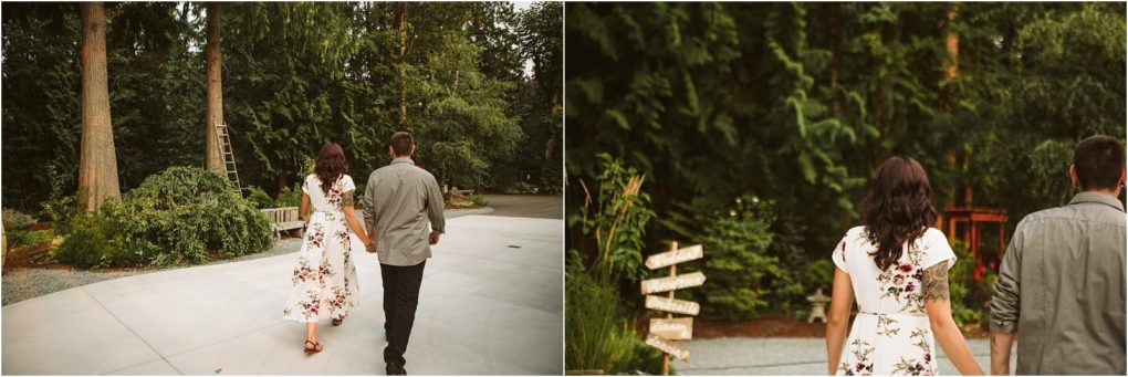 Premier snohomish & seattle wedding photographer | gsquared weddings photography a woman in a floral dress and a man in a gray shirt walk together down a path surrounded by tall trees and greenerycapturing a candid moment from their snohomish seattle wedding engagement | serving snohomish seattle                   & beyond