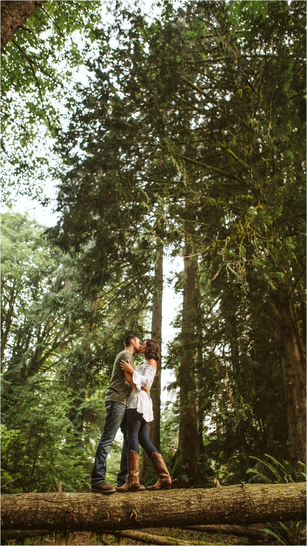 Premier snohomish & seattle wedding photographer | gsquared weddings photography a couple stands on a fallen log in a lush forest near snohomish embracing and smiling at each other Tall trees surround them creating a romantic atmosphere perfect for a seattle wedding engagement | serving snohomish seattle                   & beyond