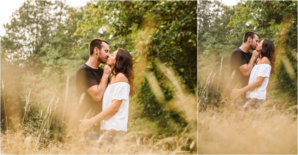 Premier snohomish & seattle wedding photographer | gsquared weddings photography a couple stands in tall grass and kisses surrounded by greenery and trees in the background The warm romantic scene captures a snohomish seattle engagement with the man in a black shirt and the woman in an off the shoulder white top | serving snohomish seattle                   & beyond