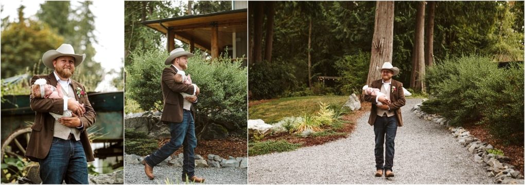 Premier snohomish & seattle wedding photographer | gsquared weddings photography a man in a cowboy hat and brown jacket gently carries a baby in a pink blanket outdoors walking along a gravel path surrounded by greenery and trees capturing a tender moment reminiscent of a snohomish seattle engagement | serving snohomish seattle                   & beyond