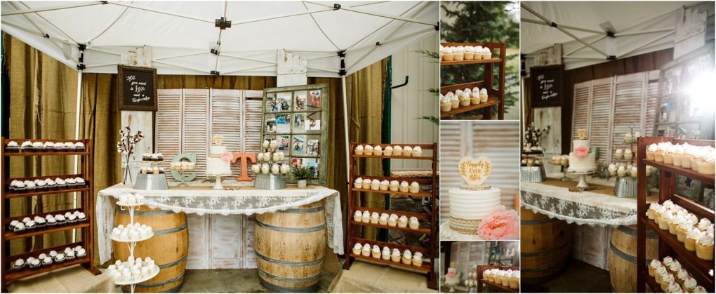 Premier snohomish & seattle wedding photographer | gsquared weddings photography a rustic snohomish wedding dessert table display under a canopy features cupcakes on wooden shelves a white cake with topper lace tablecloth wooden barrels as supports mason jar decor and framed photos hanging on shutters | serving snohomish seattle                   & beyond