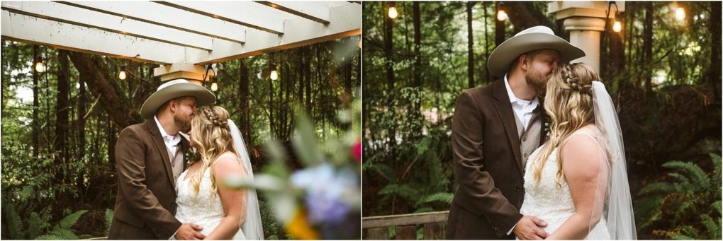 Premier snohomish & seattle wedding photographer | gsquared weddings photography a bride in a white dress and a groom in a brown suit with a cowboy hat share a kiss outdoors under string lights surrounded by green trees and ferns at their romantic snohomish seattle wedding | serving snohomish seattle                   & beyond