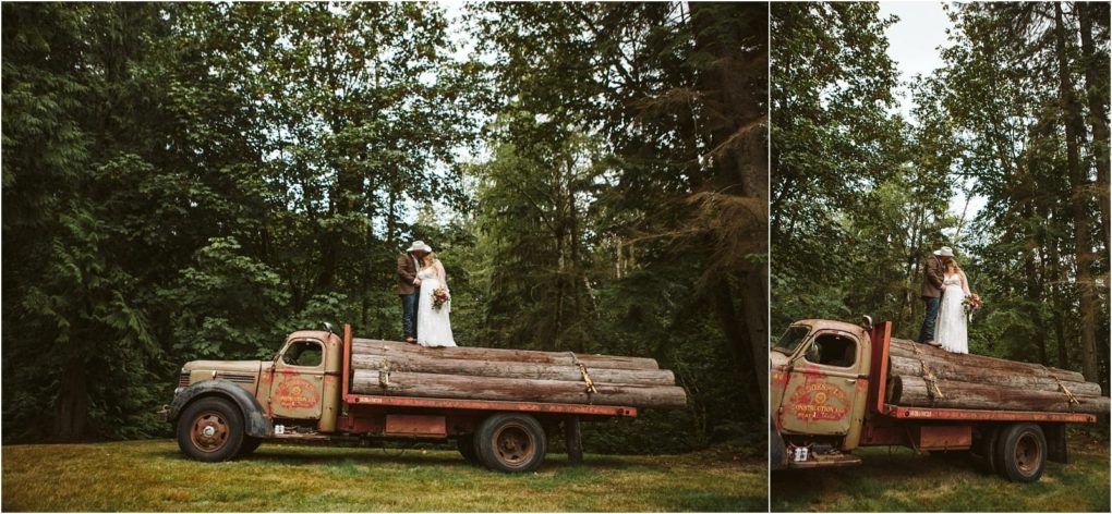 Premier snohomish & seattle wedding photographer | gsquared weddings photography a bride and groom stand on the back of a vintage red logging truck loaded with logs surrounded by tall green trees in a forested outdoor settingperfect for a unique snohomish seattle wedding or engagement shoot | serving snohomish seattle                   & beyond