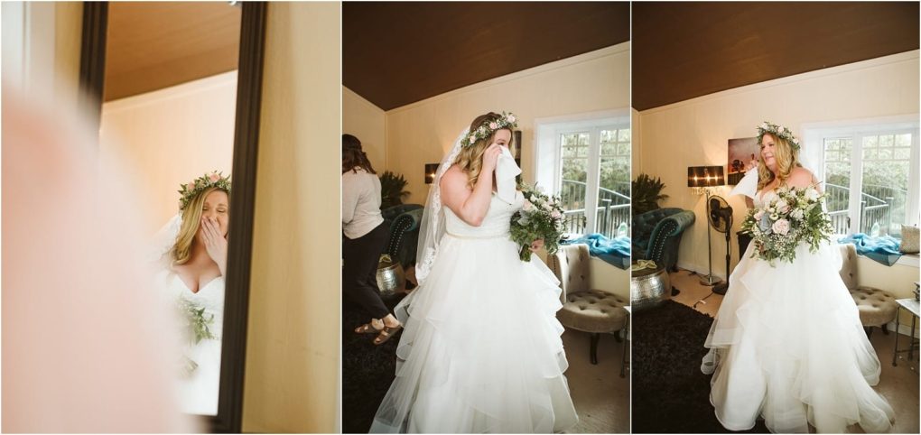 Premier snohomish & seattle wedding photographer | gsquared weddings photography a bride in a white dress and floral crown stands indoors visibly emotional and wiping tears holding a bouquet The warm candid scene captures her getting ready before her snohomish seattle wedding ceremony | serving snohomish seattle                   & beyond