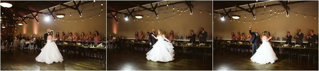Premier snohomish & seattle wedding photographer | gsquared weddings photography a bride and groom share their first dance in a warmly lit snohomish reception hall with bridesmaids and groomsmen in formal attire watching and cheering from long tables decorated with greenery and string lights overhead | serving snohomish seattle                   & beyond