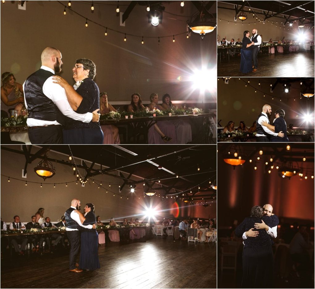 Premier snohomish & seattle wedding photographer | gsquared weddings photography a bearded man in formalwear and a woman in a navy dress share a slow dance at their snohomish wedding reception with guests seated at tables in a warmly lit hall adorned with string lights | serving snohomish seattle                   & beyond