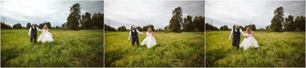 Premier snohomish & seattle wedding photographer | gsquared weddings photography a bride in a white dress and a groom in a vest and tie walk hand in hand across a green meadow under a cloudy sky surrounded by trees during their snohomish wedding engagement | serving snohomish seattle                   & beyond