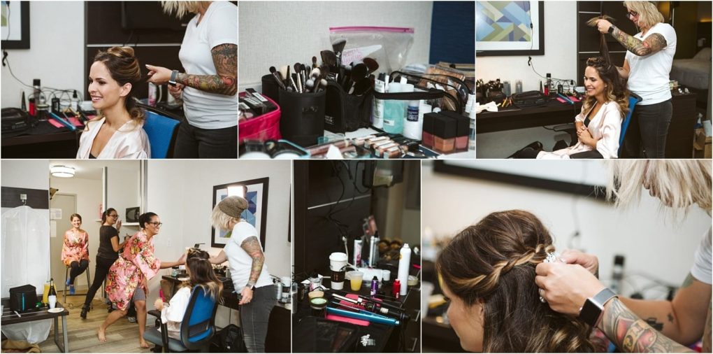 Premier snohomish & seattle wedding photographer | gsquared weddings photography a bride gets her hair styled by a tattooed stylist in a room filled with makeup and hair products before her snohomish seattle wedding Bridesmaids in floral robes watch and chat while close ups highlight hair braiding and beauty tools | serving snohomish seattle                   & beyond