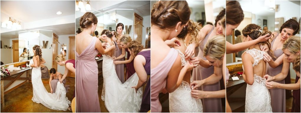 Premier snohomish & seattle wedding photographer | gsquared weddings photography in a bright room four women in mauve dresses help a bride in a white lace gown get ready for her snohomish wedding smiling as they adjust the intricate details on the back and make sure everything is perfect | serving snohomish seattle                   & beyond