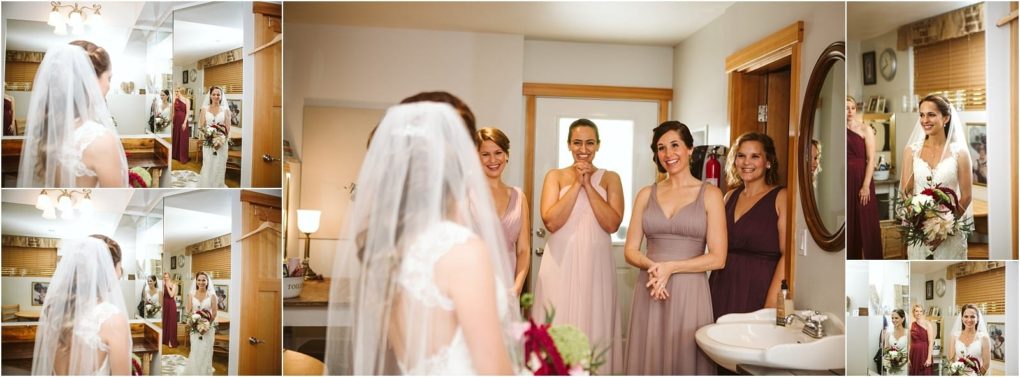 Premier snohomish & seattle wedding photographer | gsquared weddings photography a bride in a veil and white dress stands in front of a mirror smiling while three bridesmaids in mauve dresses happily look at her in a bright cozy room before their snohomish seattle wedding | serving snohomish seattle                   & beyond