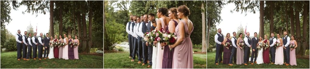 Premier snohomish & seattle wedding photographer | gsquared weddings photography a snohomish wedding party poses outdoors with three men in vests and ties and three women in mauve and pink dresses holding bouquets all standing on green grass with tall trees in the background | serving snohomish seattle                   & beyond