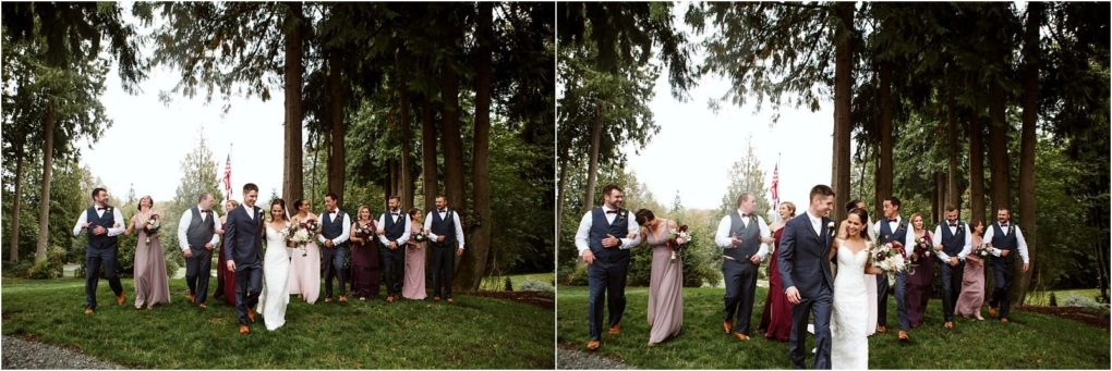 Premier snohomish & seattle wedding photographer | gsquared weddings photography a joyful snohomish wedding party walks outdoors on grass surrounded by tall trees The bride and groom lead the group with bridesmaids in mauve dresses and groomsmen in navy suits enjoying a relaxed seattle wedding celebration | serving snohomish seattle                   & beyond