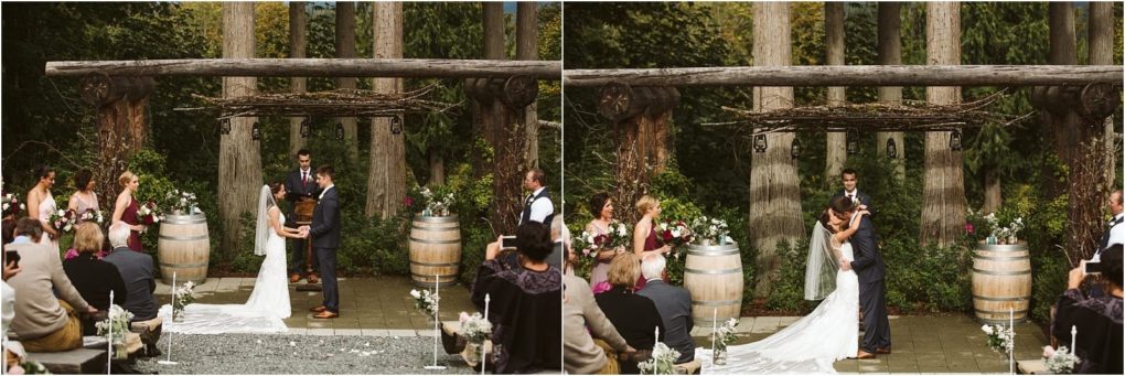 Premier snohomish & seattle wedding photographer | gsquared weddings photography a bride and groom stand under a rustic wooden arbor during a snohomish outdoor wedding ceremony surrounded by greenery guests on either side and two large wine barrels adorned with flowers Perfect for a seattle wedding engagement celebration | serving snohomish seattle                   & beyond