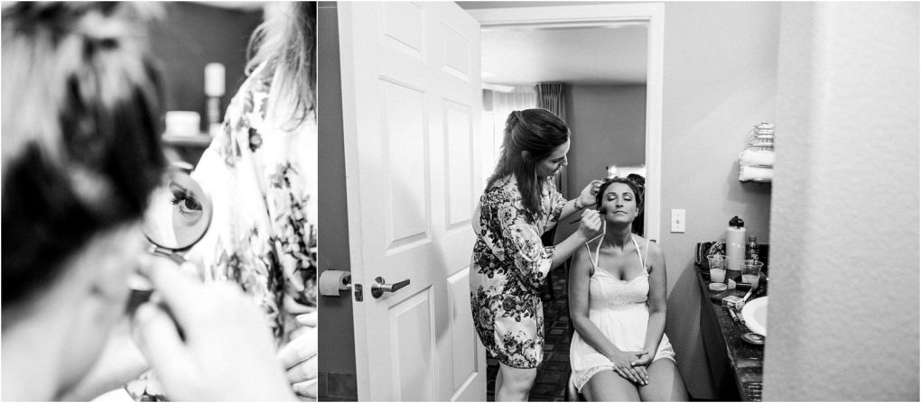 Premier snohomish & seattle wedding photographer | gsquared weddings photography a woman in a robe applies makeup to another woman who is sitting on a bathroom counter in a white tank top and shorts eyes closed This candid black and white scene captures an intimate moment before a snohomish seattle wedding or engagement | serving snohomish seattle                   & beyond