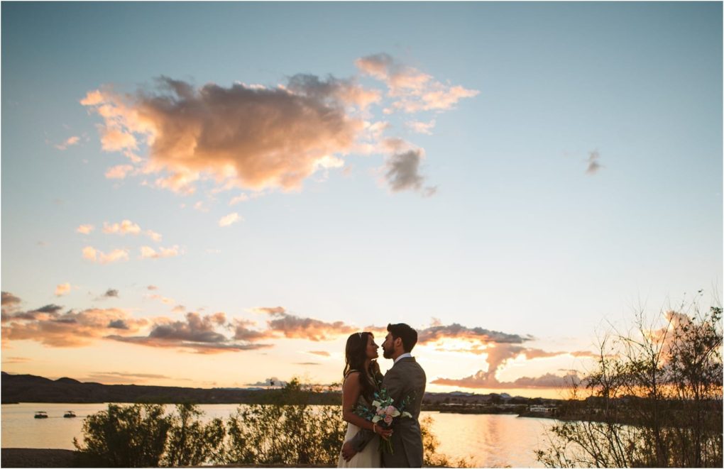 Premier snohomish & seattle wedding photographer | gsquared weddings photography a couple stands close together by a lake at sunset near snohomish surrounded by bushes and trees with colorful clouds and a glowing sky in the backgrounda romantic seattle wedding engagement scene | serving snohomish seattle                   & beyond
