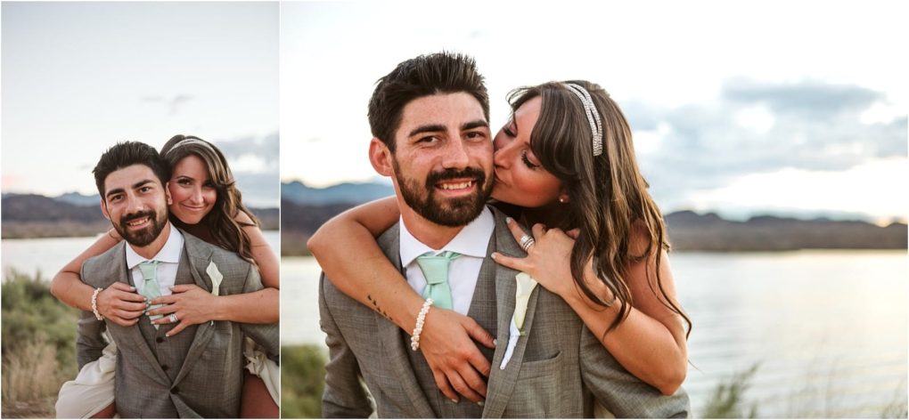 Premier snohomish & seattle wedding photographer | gsquared weddings photography a woman in a white dress hugs and kisses a smiling man in a gray suit and mint green tie from behind during their snohomish seattle wedding They stand outdoors near water with mountains and a cloudy sky in the background | serving snohomish seattle                   & beyond