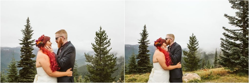 Premier snohomish & seattle wedding photographer | gsquared weddings photography a bride with long red hair and a groom with short blond hair and glasses stand outdoors on a misty forested mountain near snohomish embracing and kissing in their wedding attire Evergreen trees surround them under a cloudy seattle sky | serving snohomish seattle                   & beyond