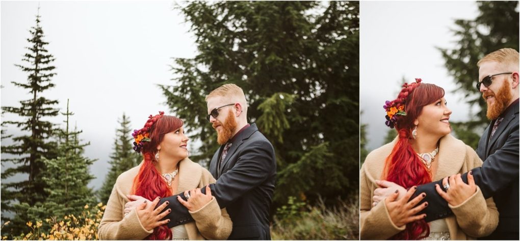 Premier snohomish & seattle wedding photographer | gsquared weddings photography a couple with red hair and beards wearing cozy jackets stand outdoors in front of evergreen trees They smile at each other warmly the womans hair adorned with colorful flowersa perfect snohomish seattle wedding engagement moment | serving snohomish seattle                   & beyond