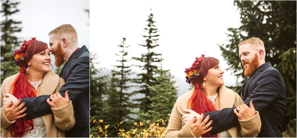 Premier snohomish & seattle wedding photographer | gsquared weddings photography a couple with red hair stands outdoors in snohomish smiling and embracing each other among evergreen trees The woman wears a tan coat and floral crown while the man in a dark suit shares this joyful seattle wedding engagement moment | serving snohomish seattle                   & beyond