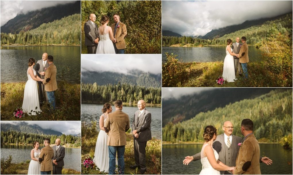 Premier snohomish & seattle wedding photographer | gsquared weddings photography a bride and groom exchange vows at a snohomish lakeside wedding ceremony accompanied by an officiant with mountains and evergreen trees in the background under a partly cloudy seattle sky | serving snohomish seattle                   & beyond