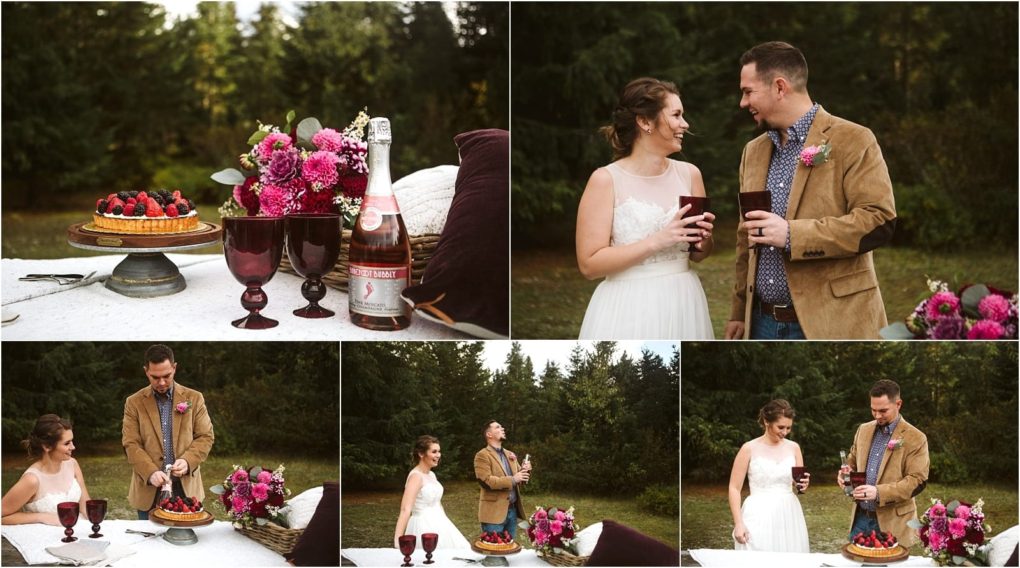 Premier snohomish & seattle wedding photographer | gsquared weddings photography a couple enjoys a picnic outdoors with wine cake and flowers on a white tablecloth Smiling and holding glasses they celebrate their snohomish seattle wedding engagement in a grassy area surrounded by trees | serving snohomish seattle                   & beyond