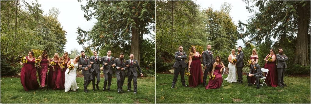 Premier snohomish & seattle wedding photographer | gsquared weddings photography a wedding party poses outdoors in front of tall trees at a beautiful snohomish seattle wedding The group includes a bride in white bridesmaids in burgundy dresses and groomsmen in grey suits all smiling and holding bouquets of sunflowers | serving snohomish seattle                   & beyond
