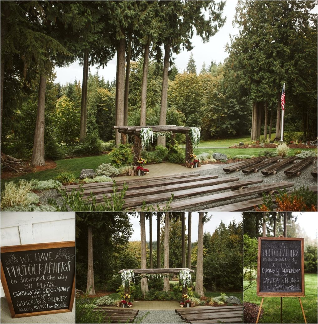Premier snohomish & seattle wedding photographer | gsquared weddings photography a rustic snohomish outdoor wedding ceremony site features wooden benches a wooden arbor with white flowers and greenery surrounded by tall trees Two chalkboard signs ask guests not to use cameras or phones during the ceremony | serving snohomish seattle                   & beyond