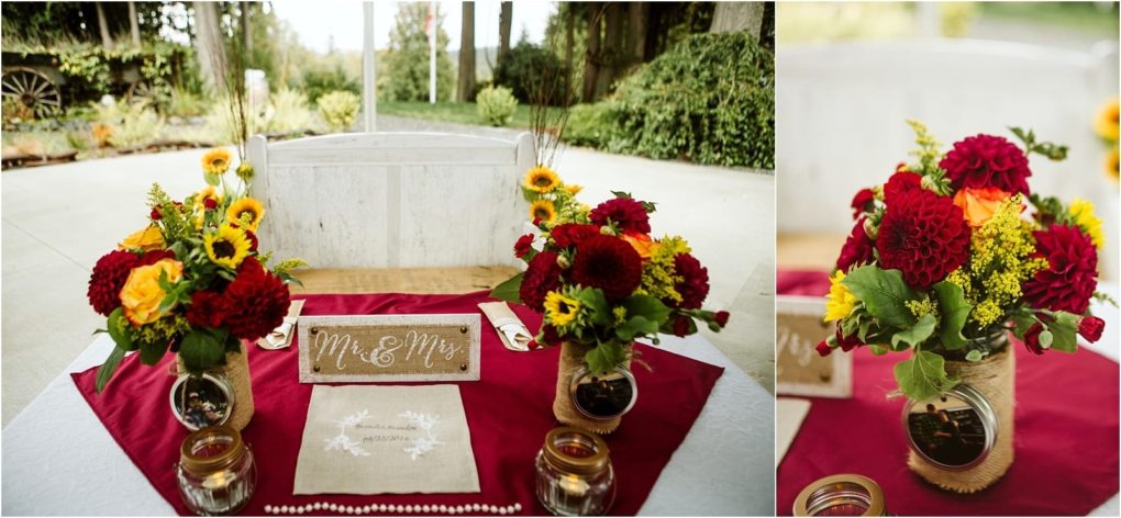 Premier snohomish & seattle wedding photographer | gsquared weddings photography a table decorated for a snohomish wedding with red and yellow flower arrangements in jars a red table runner candles and a mr & mrs Sign set outdoors near greenery and a rustic wheel | serving snohomish seattle                   & beyond