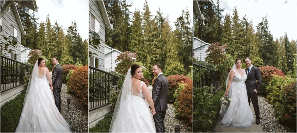 Premier snohomish & seattle wedding photographer | gsquared weddings photography a bride in a white dress and a groom in a dark suit stand outdoors near a white house holding hands and posing together against a backdrop of trees and shrubs during their snohomish seattle wedding | serving snohomish seattle                   & beyond