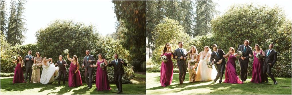 Premier snohomish & seattle wedding photographer | gsquared weddings photography a wedding party poses outdoors in sunlight at a snohomish seattle wedding with bridesmaids in magenta dresses and groomsmen in gray suits standing on grass smiling and laughing together in front of green bushes and tall trees | serving snohomish seattle                   & beyond