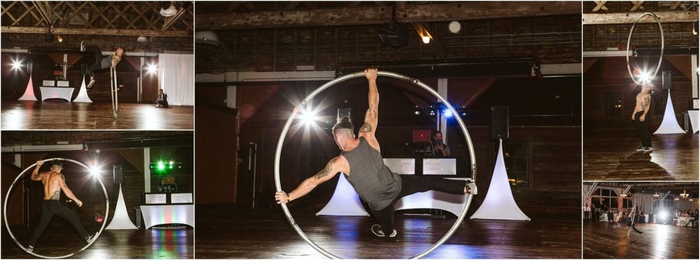 Premier snohomish & seattle wedding photographer | gsquared weddings photography a tattooed man performs acrobatics with a large metal cyr wheel on a wooden floor in a dimly lit snohomish venue with lights and dj equipment in the backgroundperfect for adding excitement to your seattle wedding or engagement celebration | serving snohomish seattle                   & beyond