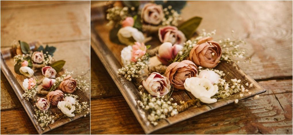 Premier snohomish & seattle wedding photographer | gsquared weddings photography a rustic wooden tray holds an arrangement of pink white and peach artificial flowersperfect for a snohomish or seattle wedding or engagementalong with green leaves and babys breath displayed on a weathered wooden table | serving snohomish seattle                   & beyond