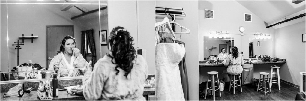 Premier snohomish & seattle wedding photographer | gsquared weddings photography black and white photo of a woman in a robe sitting at a makeup table applying makeup before her snohomish wedding A dress hangs nearby in the bright cluttered dressing room capturing the anticipation of the seattle engagement day | serving snohomish seattle                   & beyond