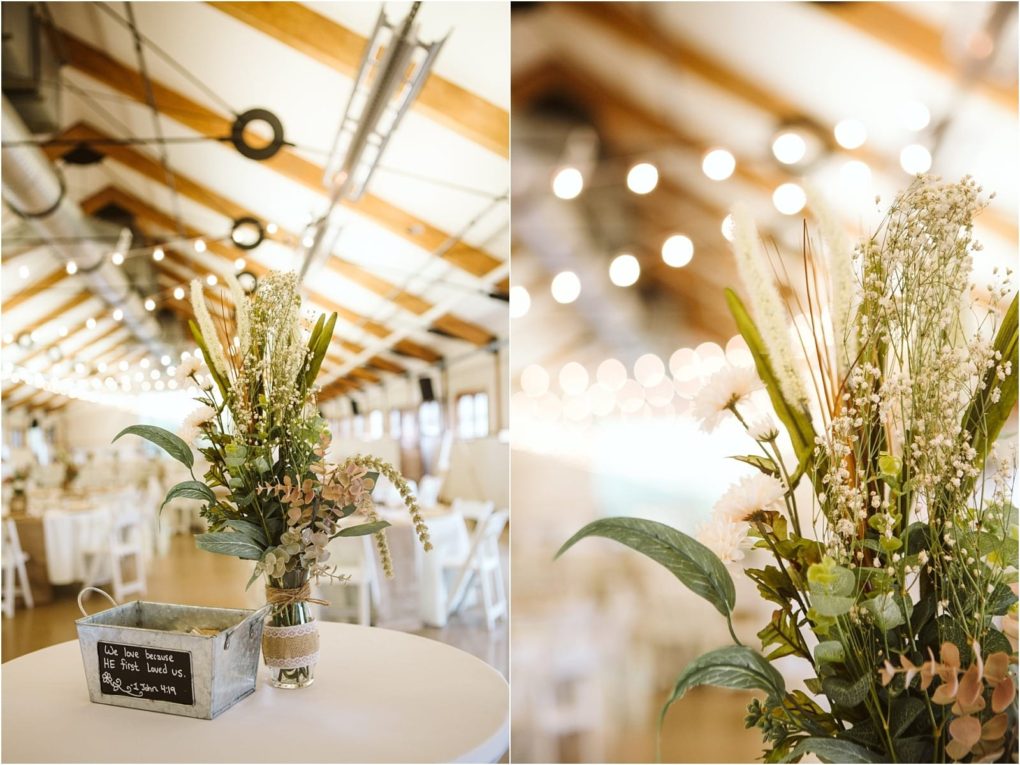 Premier snohomish & seattle wedding photographer | gsquared weddings photography a rustic indoor snohomish event space decorated with string lights featuring a close up of a floral arrangement with greenery and white flowers on a table and a small metal container with a chalkboard labelperfect for seattle wedding or engagement celebrations | serving snohomish seattle                   & beyond