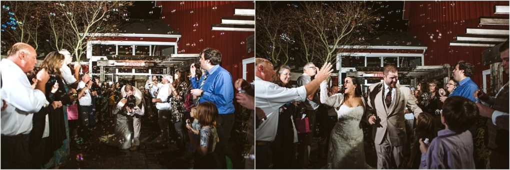 Premier snohomish & seattle wedding photographer | gsquared weddings photography a newlywed couple walks joyfully through a crowd of cheering guests blowing bubbles outdoors at night the bride wears a white dress and the groom a light suit everyone is celebrating in front of a rustic red building at this snohomish wedding | serving snohomish seattle                   & beyond