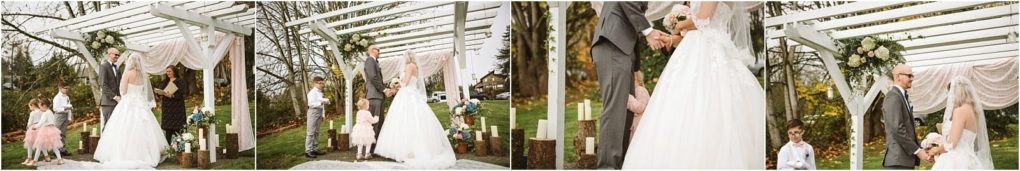 Premier snohomish & seattle wedding photographer | gsquared weddings photography a bride and groom stand holding hands under a white pergola decorated with flowers during an outdoor snohomish wedding ceremony Two young flower girls stand nearby with trees and greenery in the background | serving snohomish seattle                   & beyond