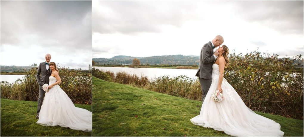 Premier snohomish & seattle wedding photographer | gsquared weddings photography a bride in a white gown and a groom in a gray suit stand together on green grass near a lake in snohomish surrounded by bushes and distant hills under a cloudy skya perfect seattle wedding engagement scene | serving snohomish seattle                   & beyond